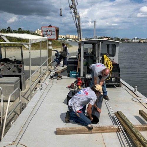 EMC Divers crew performing deck work on a marine construction barge in Florida