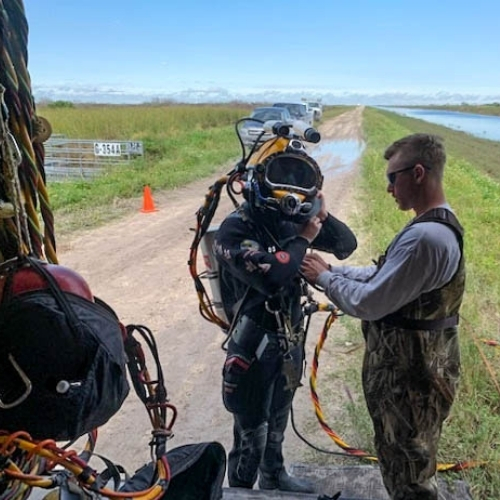 ADCI-certified commercial diver suiting up with a surface support tender