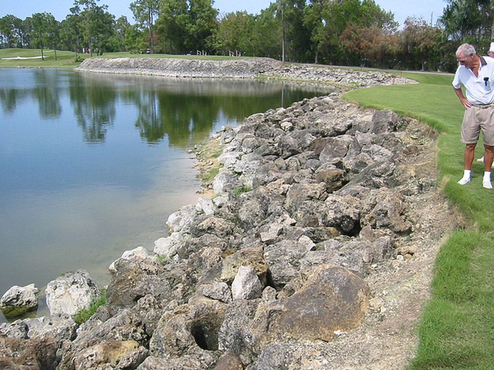 Riprap-lined golf course pond bank before Geo Tube restoration at Country Side