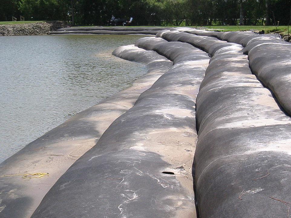Stacked Geo Tubes along a Country Side golf course water hazard during installation