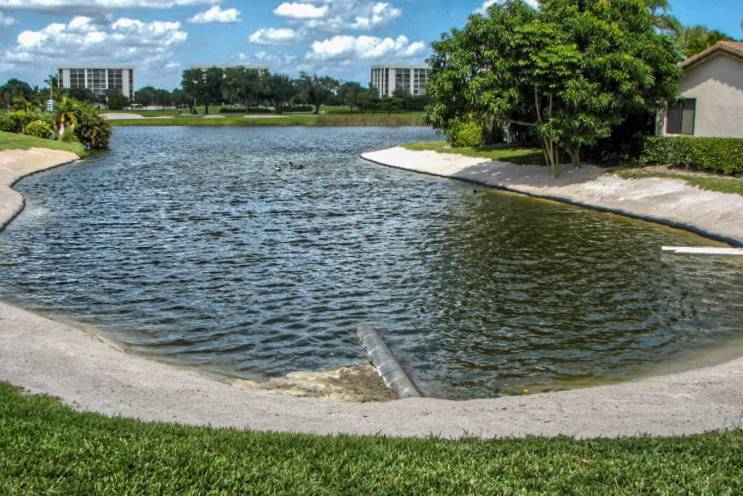 Concrete spillway and stormwater outflow at a restored golf course pond