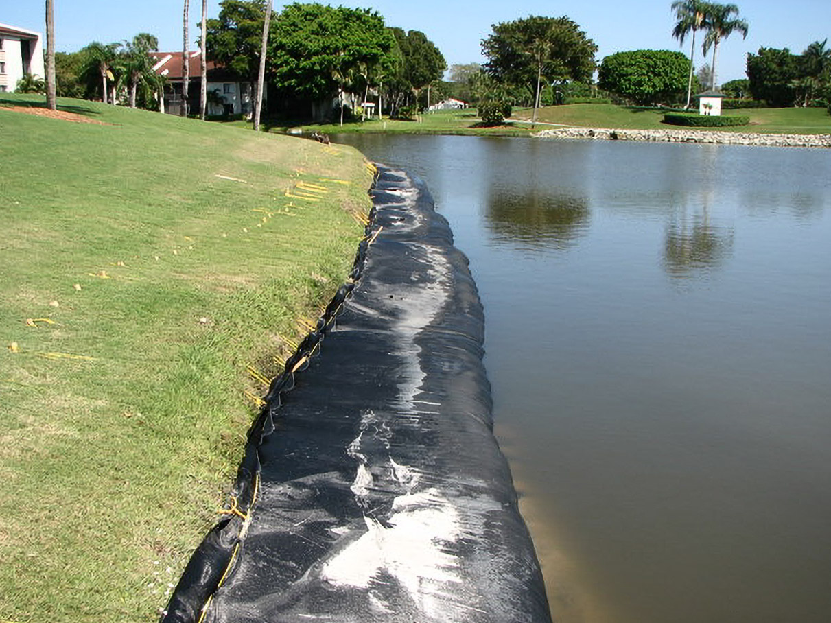 Geo Tube lining a sloped shoreline at Yacht, Golf & Tennis during restoration