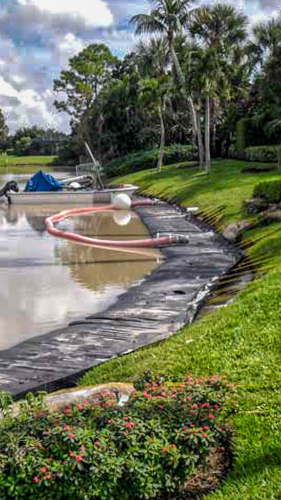Boca Raton canal restoration in progress with geotextile and silt curtain