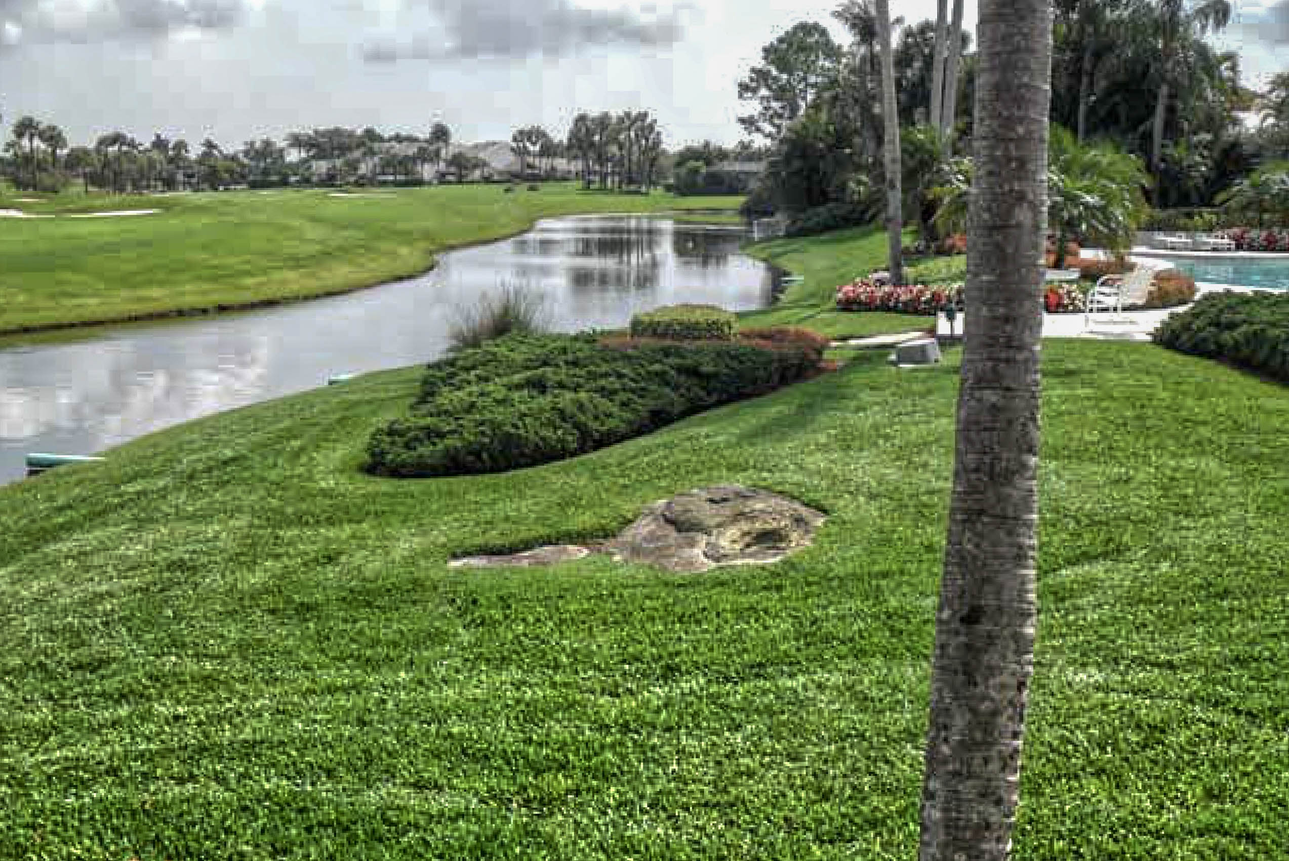 Manicured Boca Raton residential pond and lawn after lake bank stabilization