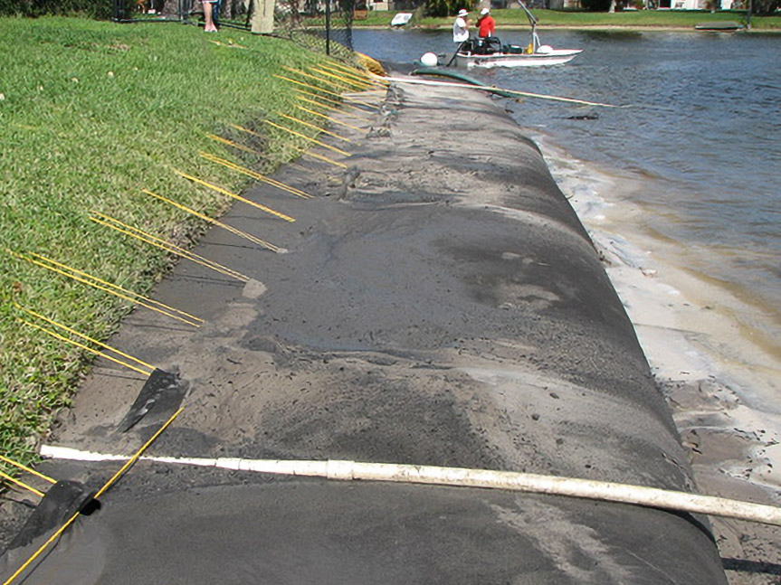 Geo Tube installation along a Davie residential shoreline with support boat nearby