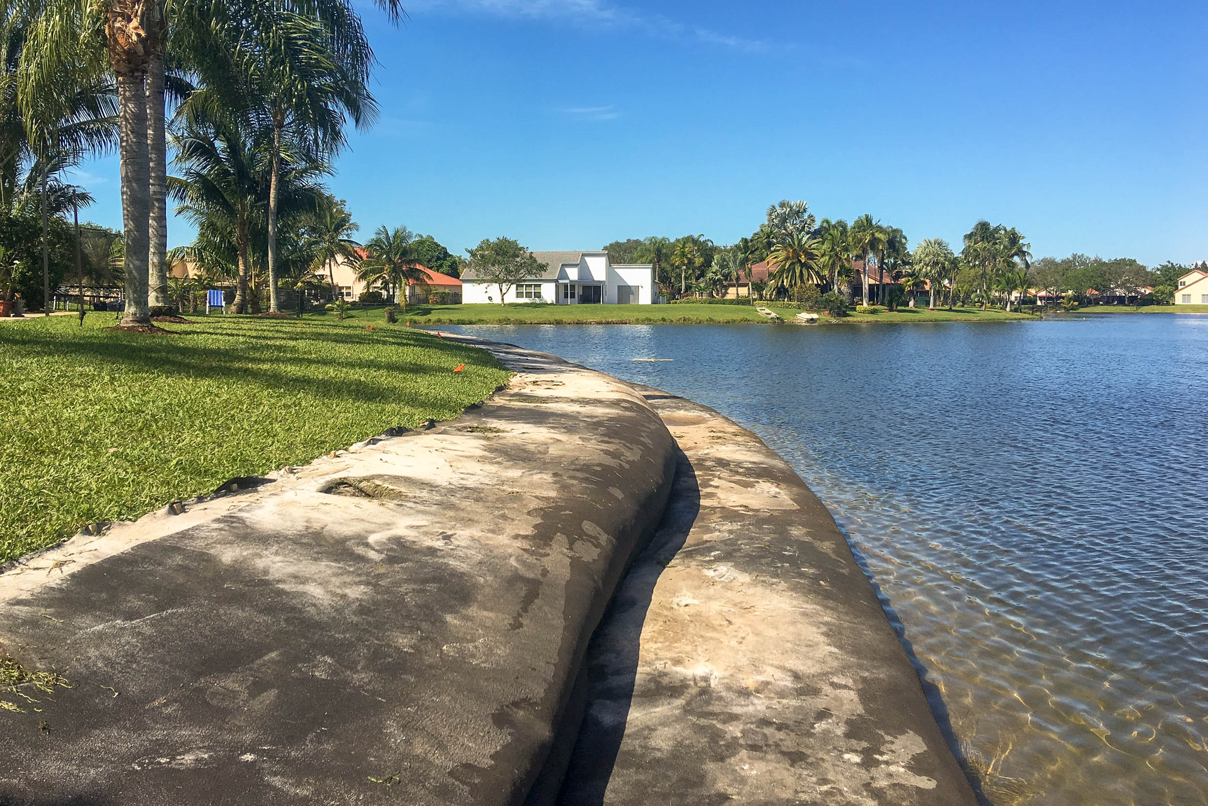 Concrete curve along a Florida residential shoreline during restoration