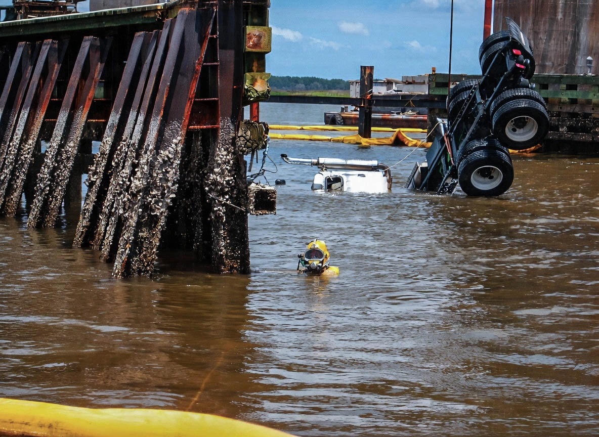 Commercial diver assisting with submerged vehicle recovery in a Florida waterway