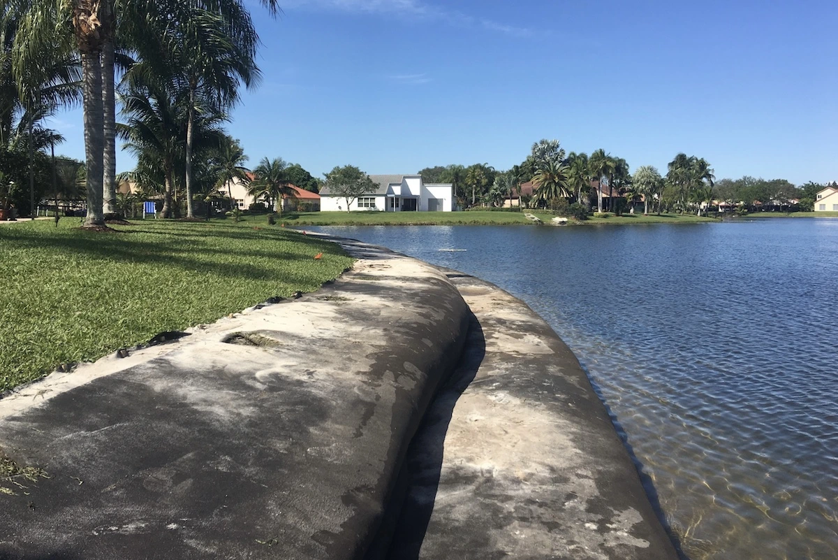 Curved Geo Tube-stabilized shoreline along a residential pond in Florida