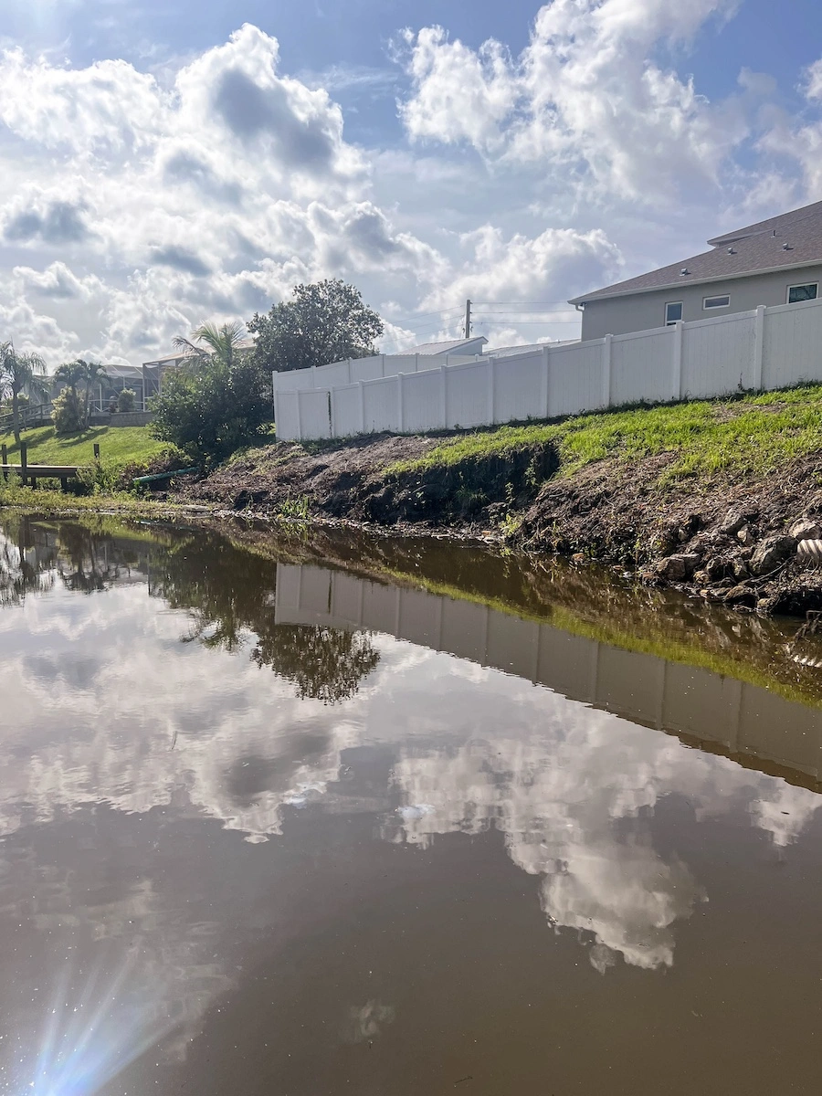 Eroded canal bank before Geo Tube restoration in Florida