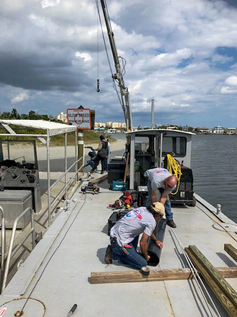 EMC Divers crew performing deck work on a marine construction barge in Florida